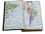 an open book with a map of the world on it
