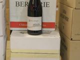 boxes stacked on top of each other with a bottle of wine on top of them