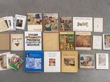 a lot of books on the floor with pictures on them