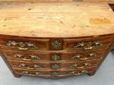 a wooden chest of drawers with brass hardware on it