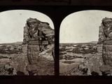 an old black and white photo of two large rocks in the desert