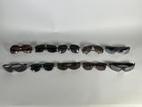 five pairs of sunglasses lined up in a row on a white surface