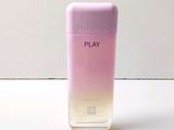 an image of a bottle of play perfume on a white surface