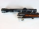 an image of a rifle with a scope on a white surface