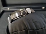 a watch that is sitting on top of a pillow