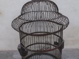 a bird cage with a bird inside of it