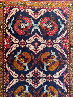 a blue rug with a red and yellow design on it