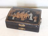 a black box with a painting on it sitting on a table