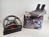 a box with a steering wheel and a game controller on it