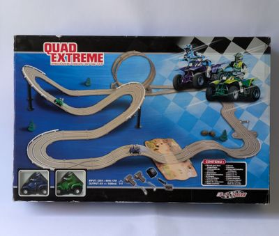 the box of a toy race track with a motorcycle and a car