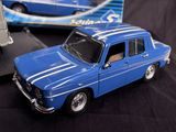 a blue toy car that is sitting on a black surface