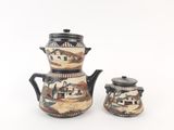 a small tea pot and a small tea pot on a white surface