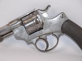 an old gun with a wooden handle on a white surface