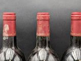 three bottles of wine sitting next to each other on a table