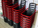 many black and red baskets lined up on the floor