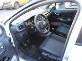 the interior of a car with the door open and the driver ' s seat down