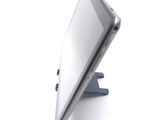 a tablet computer sitting on a stand on a white surface