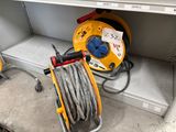 two hoses that are connected to a reel on the shelf
