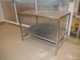 a stainless steel table in the middle of a kitchen