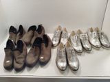 several pairs of shoes are lined up in a row on a shelf