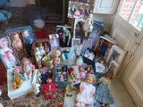 a lot of dolls and pictures on the floor