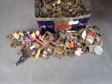 a metal container filled with assorted keys and charms