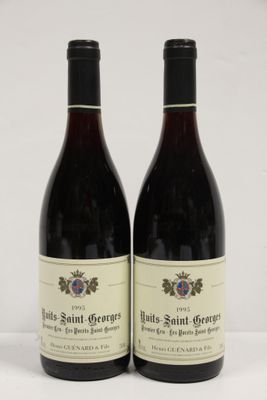 two bottles of wine sitting next to each other on a table