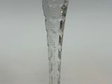 a glass candle holder with a candle inside of it
