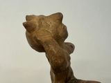 a statue of a cat that is sitting on top of a table