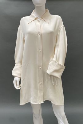 an image of a mannequin wearing a white shirt dress