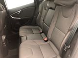a seat in the back of a car with a remote control