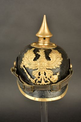 an old helmet with a golden eagle on the top of it