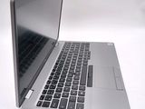 a silver laptop with a black keyboard on a white surface