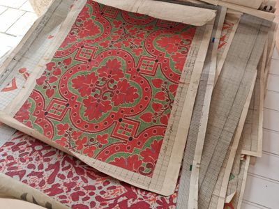 a pile of fabric on a table with a pair of scissors