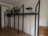 an image of a room with a shelf and a coat rack