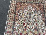 a rug on the ground with a cat sitting on it