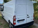 the white van is parked on the side of the road