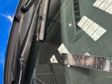 a sticker on the windshield of a car with a ruler attached to it
