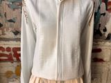 an image of a mannequin wearing a white shirt and beige shorts