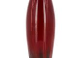 a red vase that is sitting on a white surface