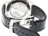 a watch that is sitting on a black leather strap