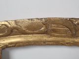a gold frame with a picture of a fish on it