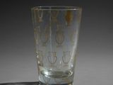 a glass that has a gold design on it