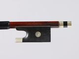 a close up of a violin bow with a piece of wood sticking out of it