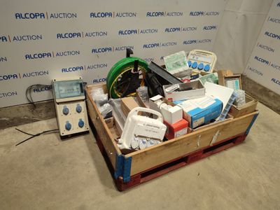 a wooden crate filled with assorted items in front of a wall