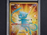 a close up of a pokemon card on a black surface