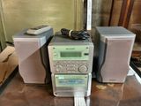 two speakers and a remote sitting on a table
