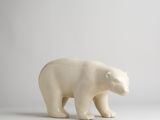 a white polar bear figurine standing on a white surface