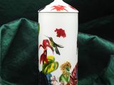 a white container with a bird and flowers on it