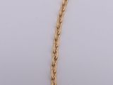 a close up of a necklace with a gold chain on a white background